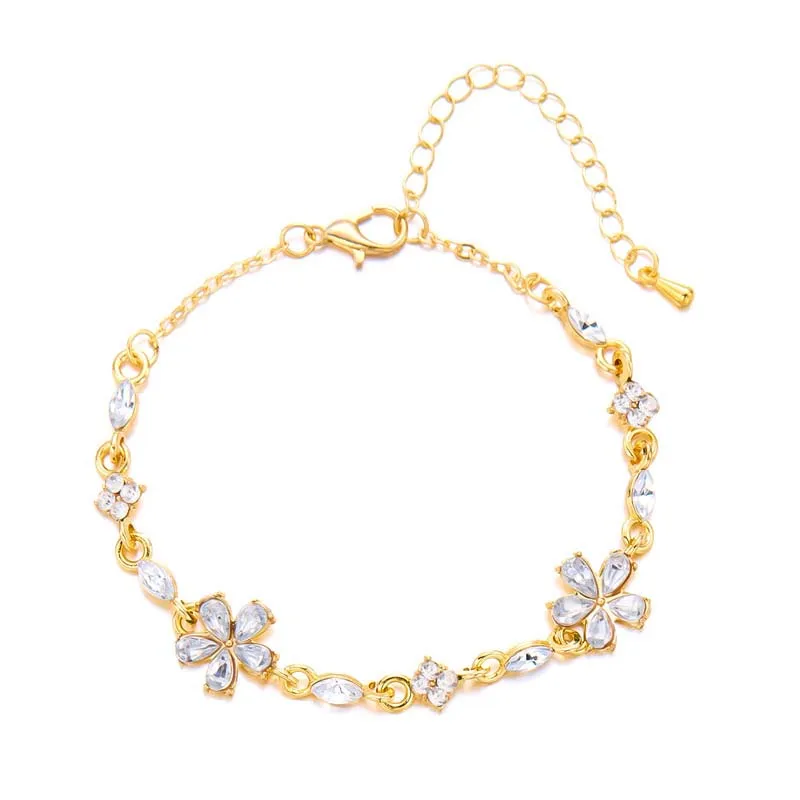 Bracelet doré avec cristaux et fleurs