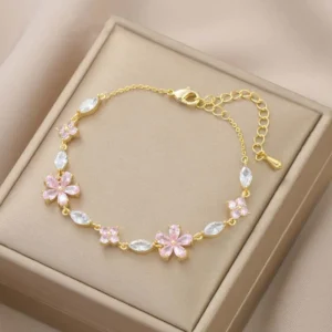 Bracelet doré avec cristaux et fleurs roses