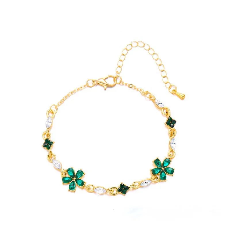Bracelet doré avec cristaux et fleurs vertes